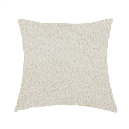 The fabric used to create this handmade cushion is a plush faux fur fabric in a pale oatmeal or light greige shade. The material has a dense, short-pile texture that appears incredibly soft and velvety.