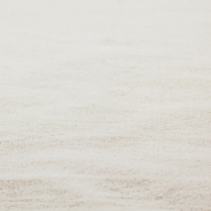 A plush faux fur fabric in a pale oatmeal or light greige shade. The material has a dense, short-pile texture that appears incredibly soft and velvety.