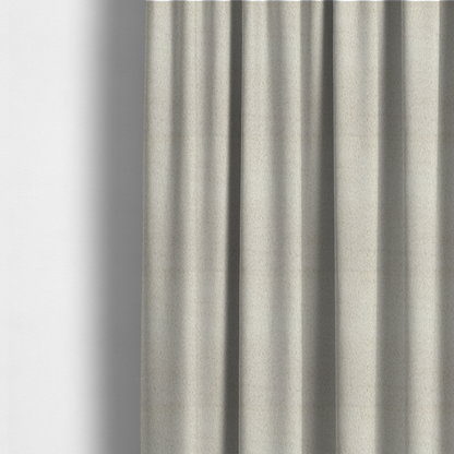 The fabric used to create these made-to-measure curtains is a plush faux fur fabric in a pale oatmeal or light greige shade. The material has a dense, short-pile texture that appears incredibly soft and velvety.