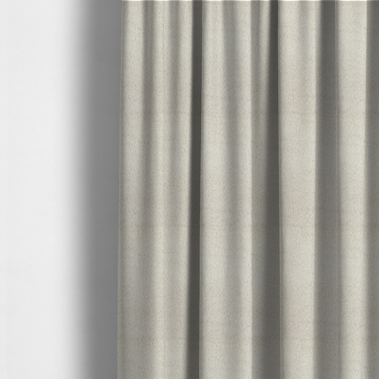 The fabric used to create these made-to-measure curtains is a plush faux fur fabric in a pale oatmeal or light greige shade. The material has a dense, short-pile texture that appears incredibly soft and velvety.