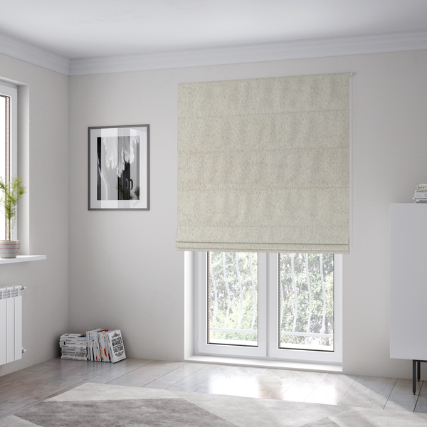 The fabric used to create these Roman blinds is a plush faux fur fabric in a pale oatmeal or light greige shade. The material has a dense, short-pile texture that appears incredibly soft and velvety.