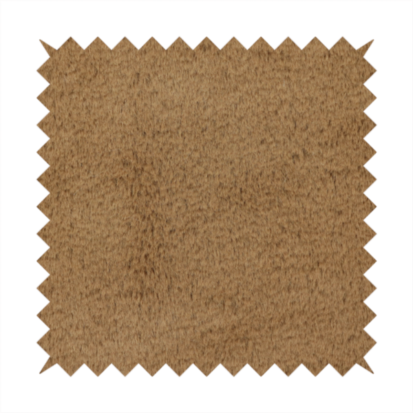 A luxurious faux fur fabric in a rich tobacco or medium brown shade. The material features a dense, velvet-like pile that creates a soft, textured surface with a subtle matte finish. The deep, warm brown colour has a natural-looking depth, with fine fibres that catch the light to reveal a plush, high-density grain.