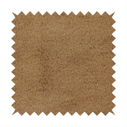 A luxurious faux fur fabric in a rich tobacco or medium brown shade. The material features a dense, velvet-like pile that creates a soft, textured surface with a subtle matte finish. The deep, warm brown colour has a natural-looking depth, with fine fibres that catch the light to reveal a plush, high-density grain.