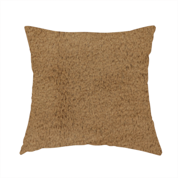 The fabric used to create this handmade cushion is a luxurious faux fur fabric in a rich tobacco or medium brown shade. The material features a dense, velvet-like pile that creates a soft, textured surface with a subtle matte finish. The deep, warm brown colour has a natural-looking depth, with fine fibres that catch the light to reveal a plush, high-density grain.