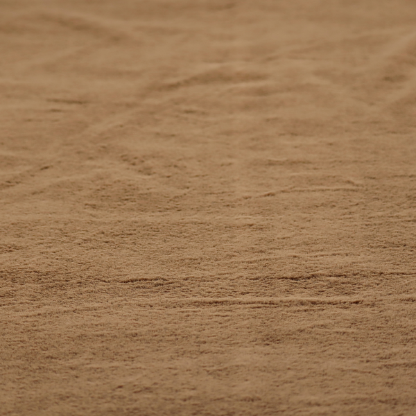 A luxurious faux fur fabric in a rich tobacco or medium brown shade. The material features a dense, velvet-like pile that creates a soft, textured surface with a subtle matte finish. The deep, warm brown colour has a natural-looking depth, with fine fibres that catch the light to reveal a plush, high-density grain.