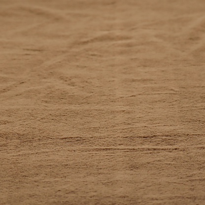 A luxurious faux fur fabric in a rich tobacco or medium brown shade. The material features a dense, velvet-like pile that creates a soft, textured surface with a subtle matte finish. The deep, warm brown colour has a natural-looking depth, with fine fibres that catch the light to reveal a plush, high-density grain.