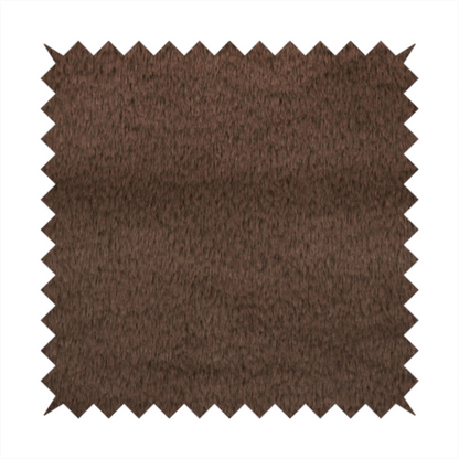 A luxurious faux fur fabric in a deep dark chocolate or espresso brown. The material features a dense, short-pile texture that creates a velvety and sophisticated appearance. The dark, cool-toned brown fibres are tightly packed, offering a soft matte finish with subtle shadows that highlight the fabric's thick and plush quality.