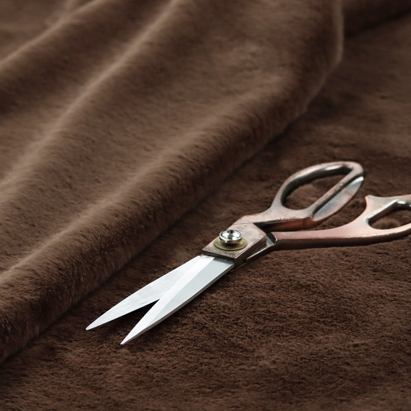 A luxurious faux fur fabric in a deep dark chocolate or espresso brown. The material features a dense, short-pile texture that creates a velvety and sophisticated appearance. The dark, cool-toned brown fibres are tightly packed, offering a soft matte finish with subtle shadows that highlight the fabric's thick and plush quality.