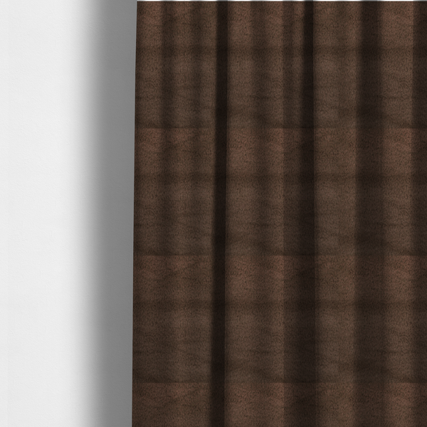 The fabric used to create these made-to-measure curtains is a luxurious faux fur fabric in a deep dark chocolate or espresso brown. The material features a dense, short-pile texture that creates a velvety and sophisticated appearance. The dark, cool-toned brown fibres are tightly packed, offering a soft matte finish with subtle shadows that highlight the fabric's thick and plush quality.