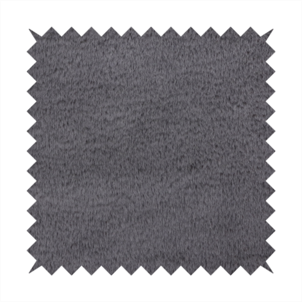 A plush faux fur fabric in a deep charcoal or slate grey. The material has a dense, short-pile texture that creates a soft, uniform surface with a subtle velvety sheen. The cool-toned grey fibres are tightly packed, providing a rich matte finish that catches the light to reveal fine depth and a luxurious hand-feel.