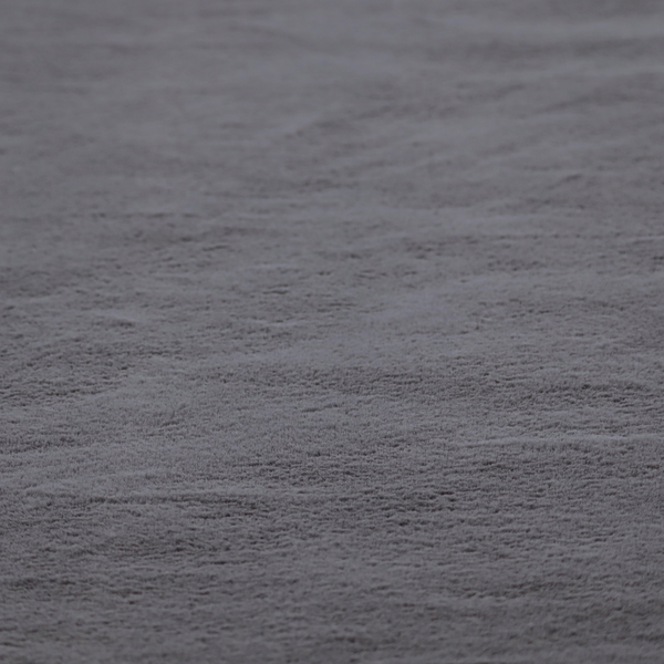 A plush faux fur fabric in a deep charcoal or slate grey. The material has a dense, short-pile texture that creates a soft, uniform surface with a subtle velvety sheen. The cool-toned grey fibres are tightly packed, providing a rich matte finish that catches the light to reveal fine depth and a luxurious hand-feel.