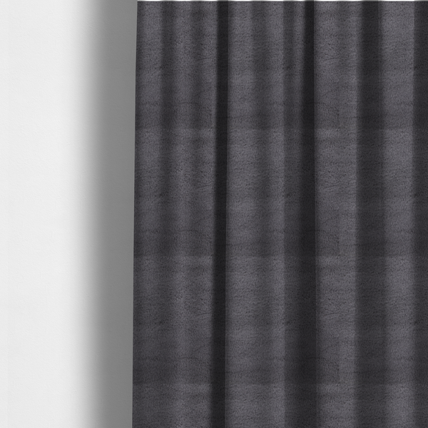 The fabric used to create these made-to-measure curtains is a plush faux fur fabric in a deep charcoal or slate grey. The material has a dense, short-pile texture that creates a soft, uniform surface with a subtle velvety sheen. The cool-toned grey fibres are tightly packed, providing a rich matte finish that catches the light to reveal fine depth and a luxurious hand-feel.