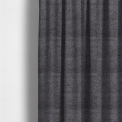 The fabric used to create these made-to-measure curtains is a plush faux fur fabric in a deep charcoal or slate grey. The material has a dense, short-pile texture that creates a soft, uniform surface with a subtle velvety sheen. The cool-toned grey fibres are tightly packed, providing a rich matte finish that catches the light to reveal fine depth and a luxurious hand-feel.