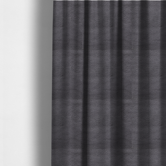 The fabric used to create these made-to-measure curtains is a plush faux fur fabric in a deep charcoal or slate grey. The material has a dense, short-pile texture that creates a soft, uniform surface with a subtle velvety sheen. The cool-toned grey fibres are tightly packed, providing a rich matte finish that catches the light to reveal fine depth and a luxurious hand-feel.