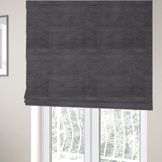 The fabric used to create these Roman blinds is a plush faux fur fabric in a deep charcoal or slate grey. The material has a dense, short-pile texture that creates a soft, uniform surface with a subtle velvety sheen. The cool-toned grey fibres are tightly packed, providing a rich matte finish that catches the light to reveal fine depth and a luxurious hand-feel.