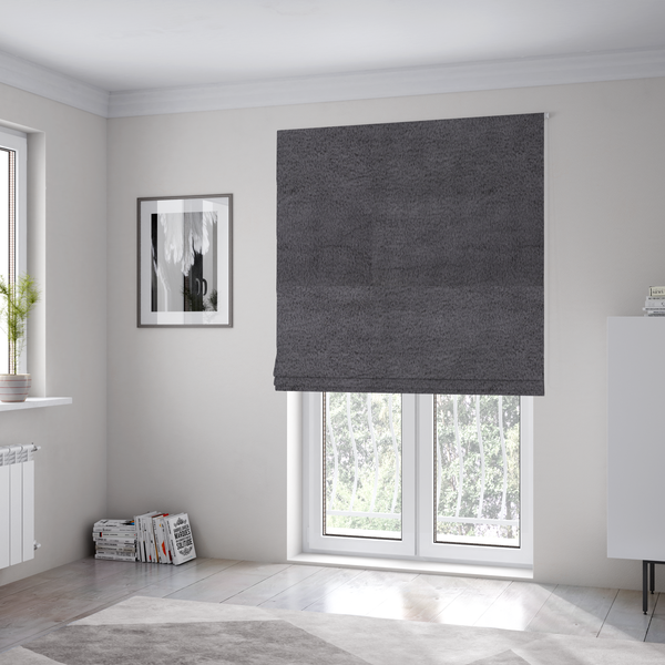 The fabric used to create these Roman blinds is a plush faux fur fabric in a deep charcoal or slate grey. The material has a dense, short-pile texture that creates a soft, uniform surface with a subtle velvety sheen. The cool-toned grey fibres are tightly packed, providing a rich matte finish that catches the light to reveal fine depth and a luxurious hand-feel.
