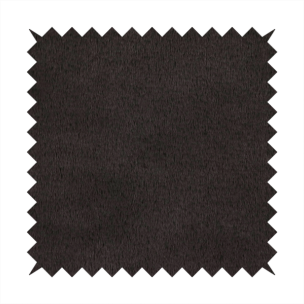 A luxurious faux fur fabric in a deep off-black or charcoal noir shade. The material has an exceptionally dense, short-pile texture that creates a rich, velvet-like surface. The dark fibres catch the light to reveal subtle, cool-toned depth, giving the fabric a sophisticated matte finish.
