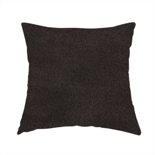 The fabric used to create this handmade cushion is a luxurious faux fur fabric in a deep off-black or charcoal noir shade. The material has an exceptionally dense, short-pile texture that creates a rich, velvet-like surface. The dark fibres catch the light to reveal subtle, cool-toned depth, giving the fabric a sophisticated matte finish.