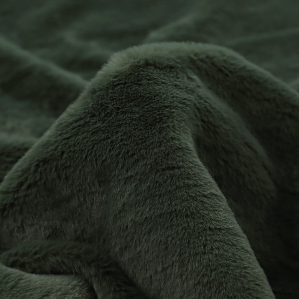 A plush faux fur fabric in a rich forest green or deep pine colour. The material has a dense, short-pile texture that creates a velvety surface with a sophisticated matte finish. The dark green fibres are tightly packed, showing subtle tonal variations and soft shadows that give the fabric a luxurious sense of depth.