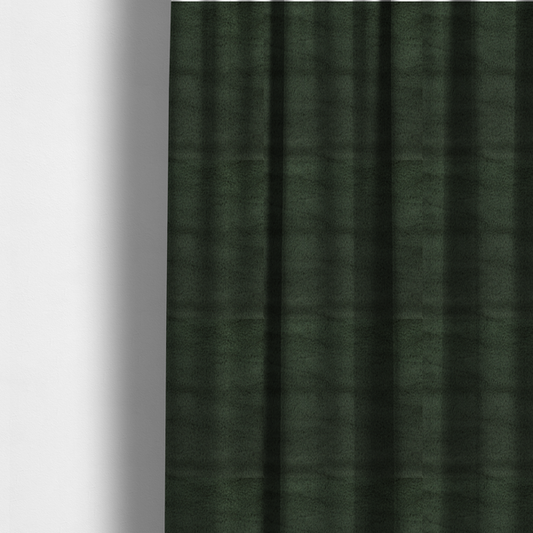 The fabric used to create these made-to-measure curtains is a plush faux fur fabric in a rich forest green or deep pine colour. The material has a dense, short-pile texture that creates a velvety surface with a sophisticated matte finish. The dark green fibres are tightly packed, showing subtle tonal variations and soft shadows that give the fabric a luxurious sense of depth.