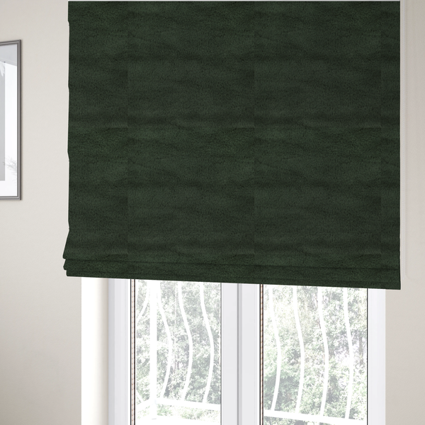 The fabric used to create these Roman blinds is a plush faux fur fabric in a rich forest green or deep pine colour. The material has a dense, short-pile texture that creates a velvety surface with a sophisticated matte finish. The dark green fibres are tightly packed, showing subtle tonal variations and soft shadows that give the fabric a luxurious sense of depth.