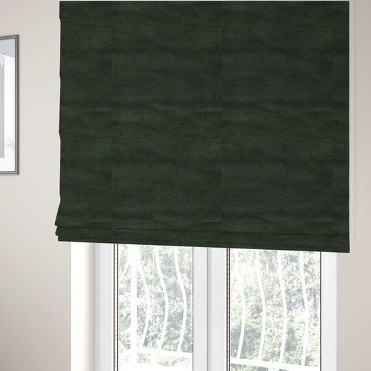 The fabric used to create these Roman blinds is a plush faux fur fabric in a rich forest green or deep pine colour. The material has a dense, short-pile texture that creates a velvety surface with a sophisticated matte finish. The dark green fibres are tightly packed, showing subtle tonal variations and soft shadows that give the fabric a luxurious sense of depth.