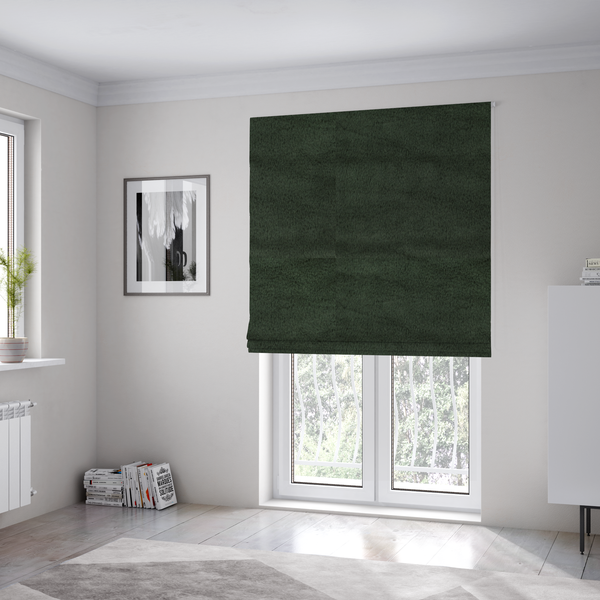 The fabric used to create these Roman blinds is a plush faux fur fabric in a rich forest green or deep pine colour. The material has a dense, short-pile texture that creates a velvety surface with a sophisticated matte finish. The dark green fibres are tightly packed, showing subtle tonal variations and soft shadows that give the fabric a luxurious sense of depth.