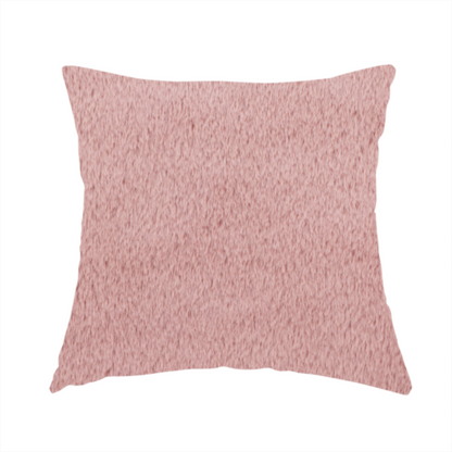The fabric used to create this handmade cushion is a plush faux fur fabric in a delicate dusty rose or muted blush pink. The material displays a dense, short-pile texture that creates a velvety surface with a soft, matte finish. The tightly packed fibres catch the light to show gentle tonal shifts, giving the fabric a romantic and luxurious sense of depth.