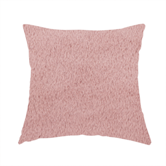 The fabric used to create this handmade cushion is a plush faux fur fabric in a delicate dusty rose or muted blush pink. The material displays a dense, short-pile texture that creates a velvety surface with a soft, matte finish. The tightly packed fibres catch the light to show gentle tonal shifts, giving the fabric a romantic and luxurious sense of depth.