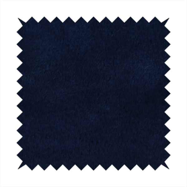 A plush faux fur fabric in a deep, classic navy blue. The material features a dense, short-pile texture that creates a rich, velvety surface with a sophisticated matte finish. The tightly packed dark blue fibres catch the light to show subtle tonal depth and soft shadows, suggesting an exceptionally soft and luxurious hand-feel.