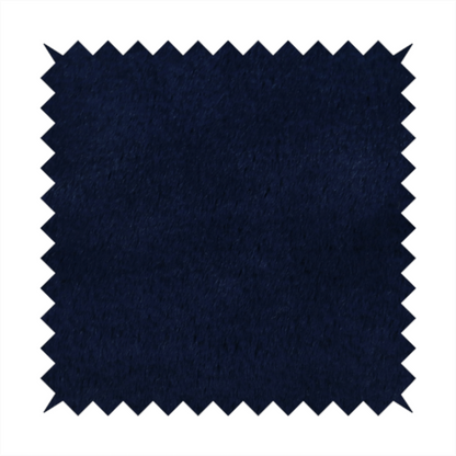 A plush faux fur fabric in a deep, classic navy blue. The material features a dense, short-pile texture that creates a rich, velvety surface with a sophisticated matte finish. The tightly packed dark blue fibres catch the light to show subtle tonal depth and soft shadows, suggesting an exceptionally soft and luxurious hand-feel.