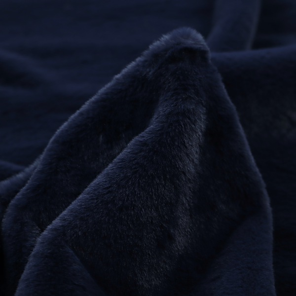 A plush faux fur fabric in a deep, classic navy blue. The material features a dense, short-pile texture that creates a rich, velvety surface with a sophisticated matte finish. The tightly packed dark blue fibres catch the light to show subtle tonal depth and soft shadows, suggesting an exceptionally soft and luxurious hand-feel.
