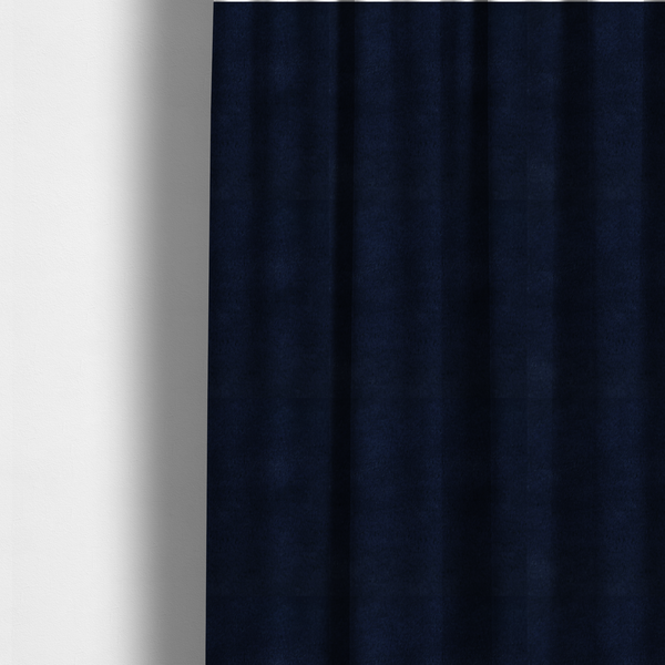 The fabric used to create these made-to-measure curtains is a plush faux fur fabric in a deep, classic navy blue. The material features a dense, short-pile texture that creates a rich, velvety surface with a sophisticated matte finish. The tightly packed dark blue fibres catch the light to show subtle tonal depth and soft shadows, suggesting an exceptionally soft and luxurious hand-feel.