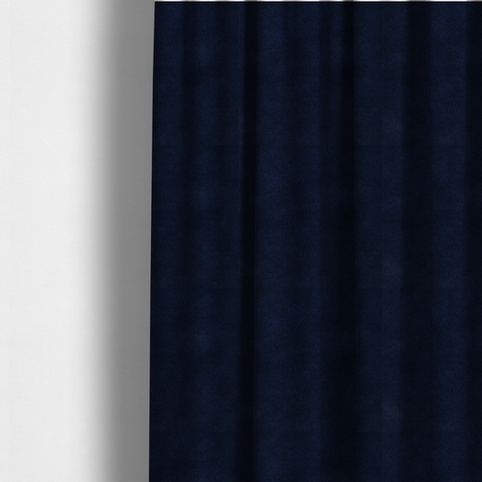 The fabric used to create these made-to-measure curtains is a plush faux fur fabric in a deep, classic navy blue. The material features a dense, short-pile texture that creates a rich, velvety surface with a sophisticated matte finish. The tightly packed dark blue fibres catch the light to show subtle tonal depth and soft shadows, suggesting an exceptionally soft and luxurious hand-feel.
