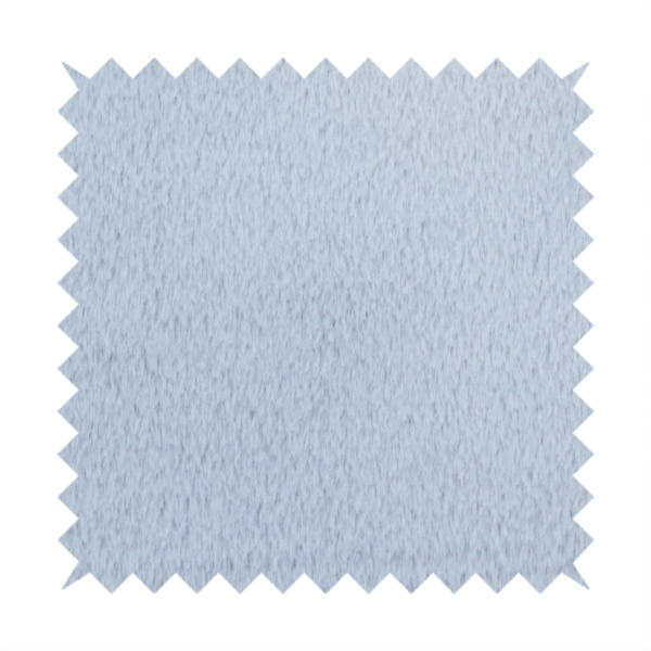 A plush faux fur fabric in a bright silver or icy light grey shade. The material has a dense, short-pile texture that creates a soft, uniform surface with a delicate matte sheen. The cool, pale grey fibres are tightly packed, showing subtle light-and-shadow variations that give the fabric a clean, velvety depth.