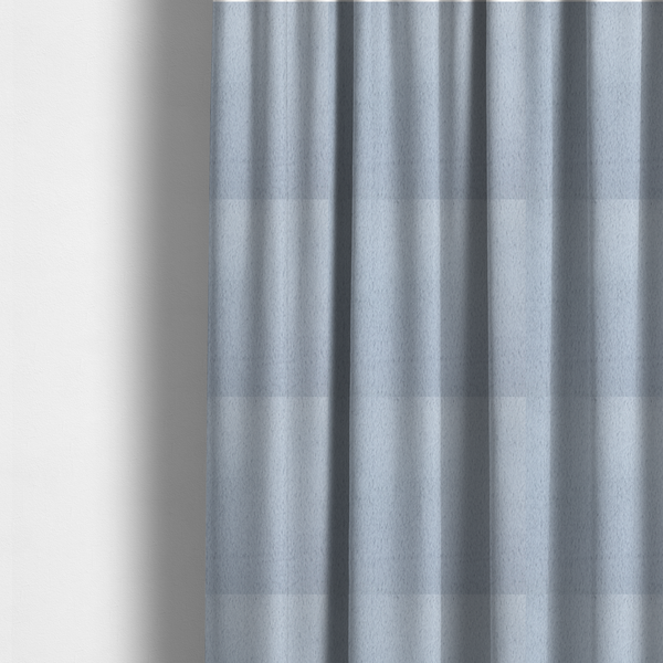 The fabric used to create these made-to-measure curtains is a plush faux fur fabric in a bright silver or icy light grey shade. The material has a dense, short-pile texture that creates a soft, uniform surface with a delicate matte sheen. The cool, pale grey fibres are tightly packed, showing subtle light-and-shadow variations that give the fabric a clean, velvety depth.