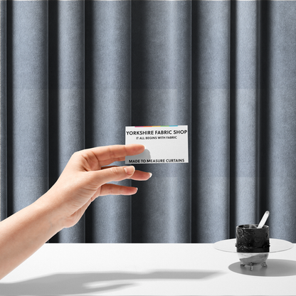 The fabric used to create these made-to-measure curtains is a plush faux fur fabric in a bright silver or icy light grey shade. The material has a dense, short-pile texture that creates a soft, uniform surface with a delicate matte sheen. The cool, pale grey fibres are tightly packed, showing subtle light-and-shadow variations that give the fabric a clean, velvety depth.