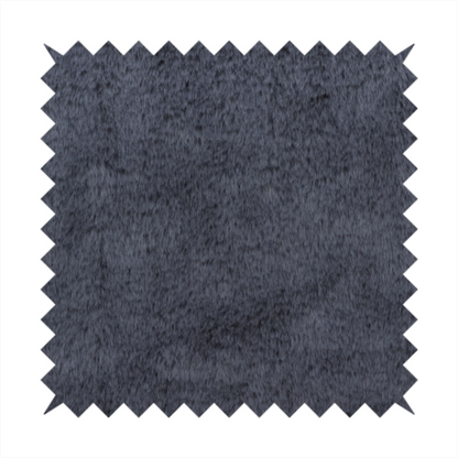 A luxurious faux fur fabric in a deep slate grey or charcoal blue shade. The material features a dense, plush, short-pile texture that creates a soft, uniform surface with a rich matte finish. The tightly packed fibres catch the light to reveal subtle, cool-toned depth and soft shadows, suggesting a velvety and sophisticated hand-feel.