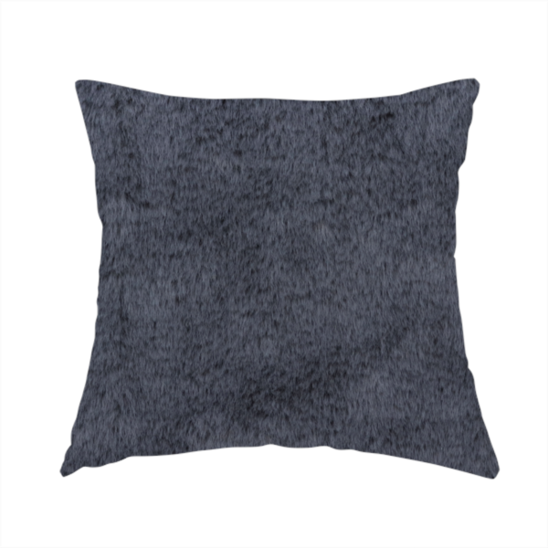 The fabric used to create this handmade cushion is a luxurious faux fur fabric in a deep slate grey or charcoal blue shade. The material features a dense, plush, short-pile texture that creates a soft, uniform surface with a rich matte finish. The tightly packed fibres catch the light to reveal subtle, cool-toned depth and soft shadows, suggesting a velvety and sophisticated hand-feel.