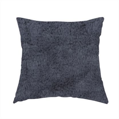 The fabric used to create this handmade cushion is a luxurious faux fur fabric in a deep slate grey or charcoal blue shade. The material features a dense, plush, short-pile texture that creates a soft, uniform surface with a rich matte finish. The tightly packed fibres catch the light to reveal subtle, cool-toned depth and soft shadows, suggesting a velvety and sophisticated hand-feel.
