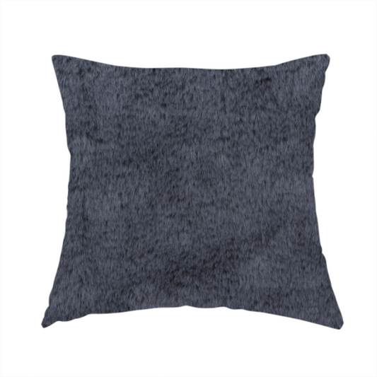The fabric used to create this handmade cushion is a luxurious faux fur fabric in a deep slate grey or charcoal blue shade. The material features a dense, plush, short-pile texture that creates a soft, uniform surface with a rich matte finish. The tightly packed fibres catch the light to reveal subtle, cool-toned depth and soft shadows, suggesting a velvety and sophisticated hand-feel.