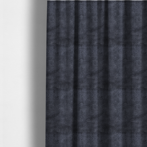 The fabric used to create these made-to-measure curtains is a luxurious faux fur fabric in a deep slate grey or charcoal blue shade. The material features a dense, plush, short-pile texture that creates a soft, uniform surface with a rich matte finish. The tightly packed fibres catch the light to reveal subtle, cool-toned depth and soft shadows, suggesting a velvety and sophisticated hand-feel.