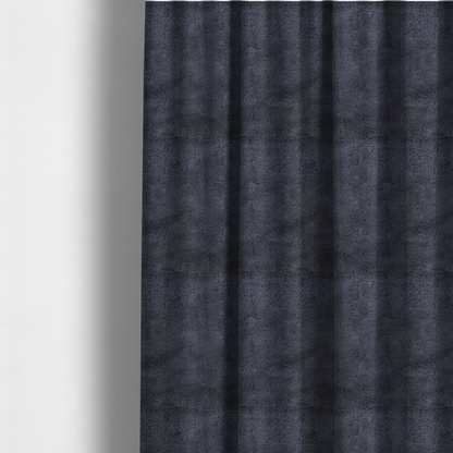 The fabric used to create these made-to-measure curtains is a luxurious faux fur fabric in a deep slate grey or charcoal blue shade. The material features a dense, plush, short-pile texture that creates a soft, uniform surface with a rich matte finish. The tightly packed fibres catch the light to reveal subtle, cool-toned depth and soft shadows, suggesting a velvety and sophisticated hand-feel.