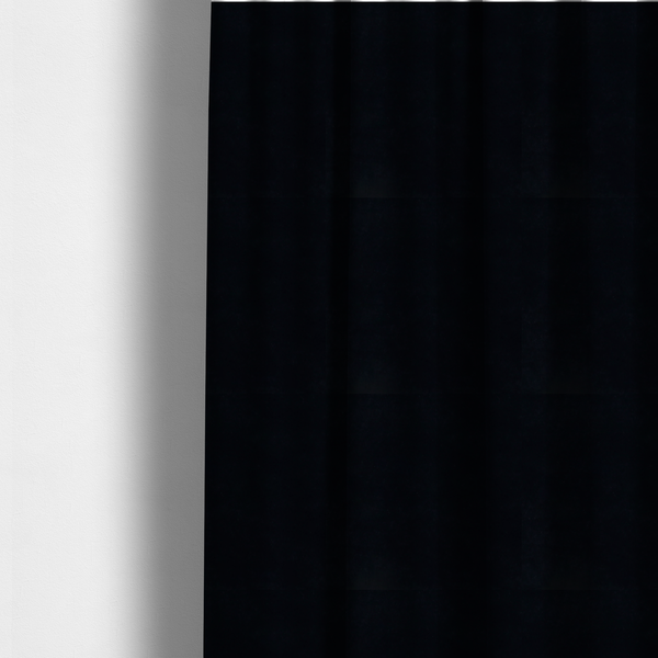 The fabric used to create these made-to-measure curtains is a luxurious faux fur fabric in a solid, true jet black. The material showcases an exceptionally dense, short-pile texture with a soft, uniform grain that creates a deep matte finish. Because of its high density, the fabric absorbs light significantly, resulting in a rich, velvety appearance with minimal sheen.