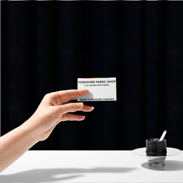 The fabric used to create these made-to-measure curtains is a luxurious faux fur fabric in a solid, true jet black. The material showcases an exceptionally dense, short-pile texture with a soft, uniform grain that creates a deep matte finish. Because of its high density, the fabric absorbs light significantly, resulting in a rich, velvety appearance with minimal sheen.