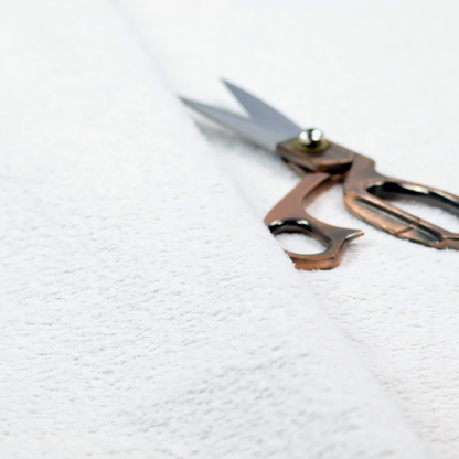 This fabric features a high-pile, textured surface that mimics the cosy appearance of shearling or faux sheepskin.