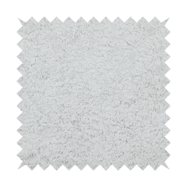 This fabric features a high-pile faux fur texture that offers a cool-toned, plush aesthetic with a rich tactile quality.