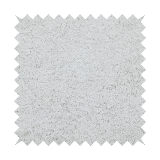 This fabric features a high-pile faux fur texture that offers a cool-toned, plush aesthetic with a rich tactile quality.