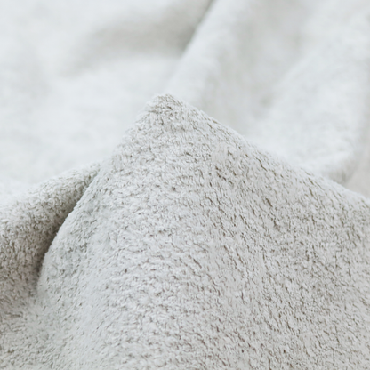 This fabric features a high-pile faux fur texture that offers a cool-toned, plush aesthetic with a rich tactile quality.