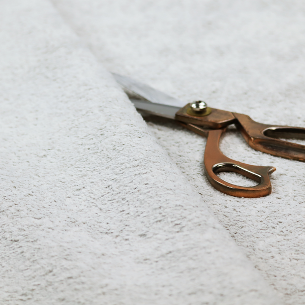 This fabric features a high-pile faux fur texture that offers a cool-toned, plush aesthetic with a rich tactile quality.